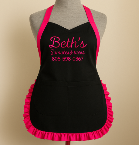 Black apron with pink ruffles and custom embroidered business logo
